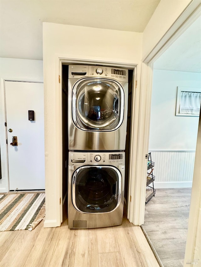 50 Via Belardo Unit 12, Greenbrae, CA 94904 - laundry area featuring stacked washer / drying machine and wood finished floors