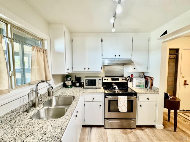 50 Via Belardo Unit 12, Greenbrae, CA 94904 - kitchen featuring stainless steel electric range oven, under cabinet range hood, light wood-style flooring, white microwave, and white cabinets
