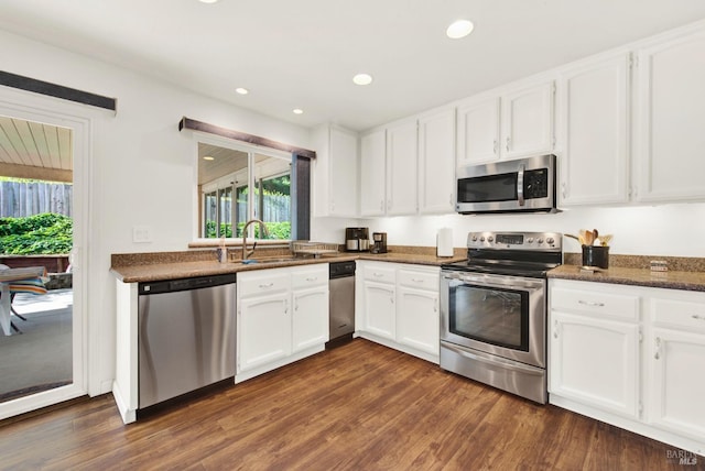 410 Duvall Ct, Benicia, CA 94510 - kitchen with dark wood-style flooring, recessed lighting, white cabinets, appliances with stainless steel finishes, and a sink