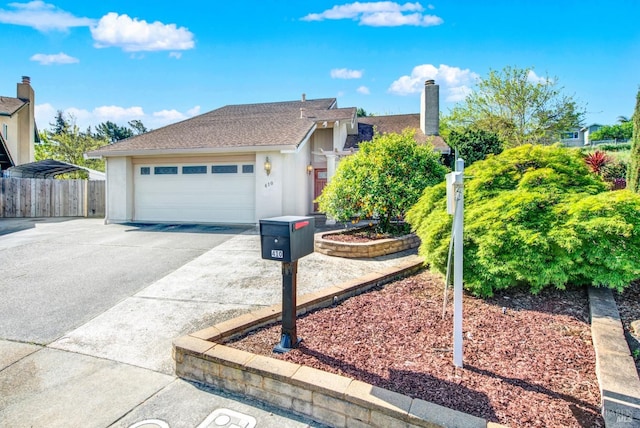 410 Duvall Ct, Benicia, CA 94510 - view of front of house with an attached garage, concrete driveway, stucco siding, and fence