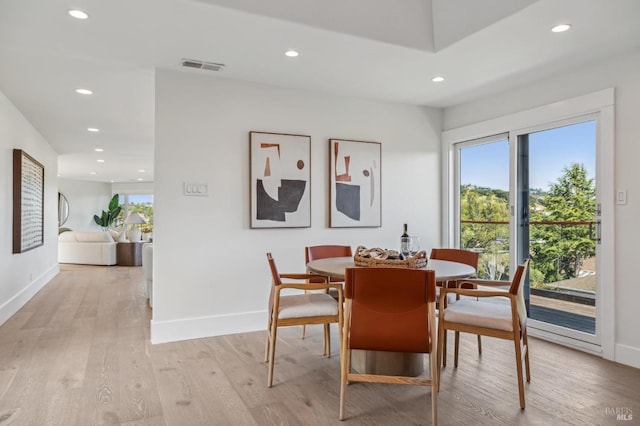 dining room featuring light wood-style floors, recessed lighting, and plenty of natural light