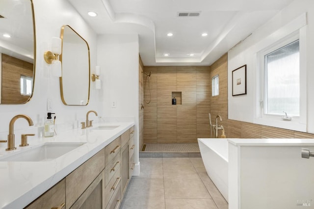 full bath with recessed lighting, visible vents, a sink, tile patterned flooring, and tiled shower