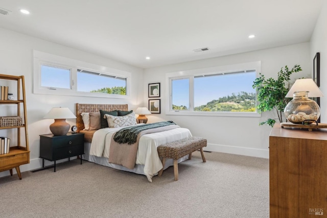 bedroom featuring baseboards, recessed lighting, visible vents, and light colored carpet