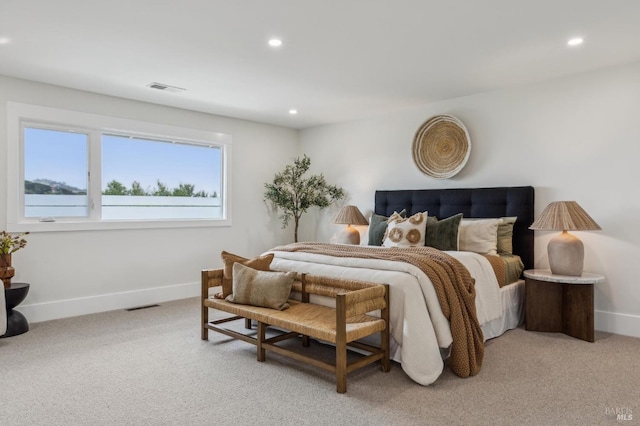 bedroom featuring baseboards, recessed lighting, light carpet, and visible vents