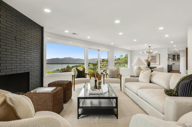 living room with light wood-style flooring, a fireplace, and recessed lighting