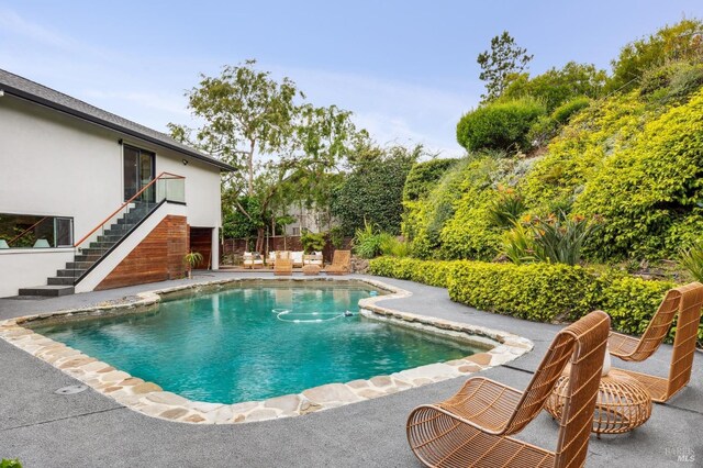 pool with stairs and a patio area