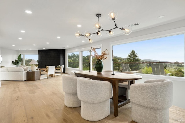 dining area featuring light wood-style floors, plenty of natural light, visible vents, and recessed lighting