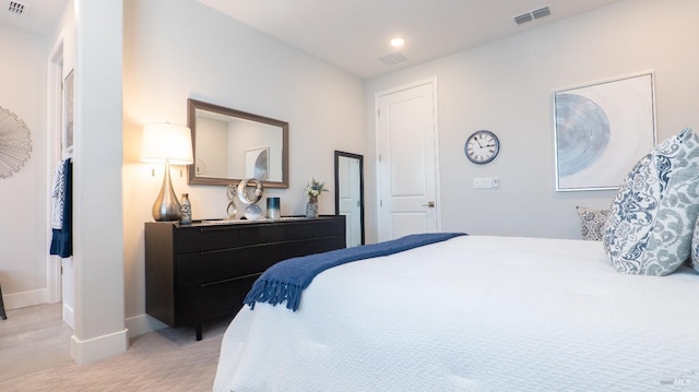 bedroom featuring visible vents, baseboards, and light colored carpet