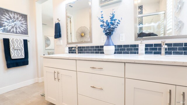 324 Pear Tree Ter Unit D, Napa, CA 94558 - bathroom featuring baseboards, double vanity, and tasteful backsplash