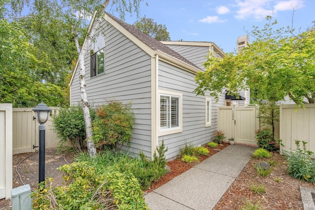 1206 Cayetano Dr, Napa, CA 94559 - view of side of home with a gate, a shingled roof, and fence