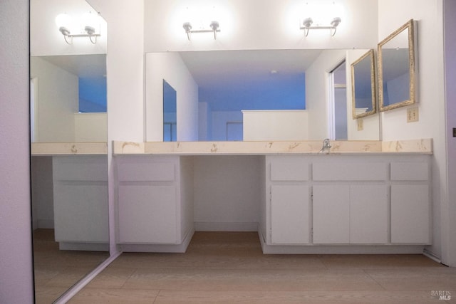 full bathroom with vanity and wood finished floors