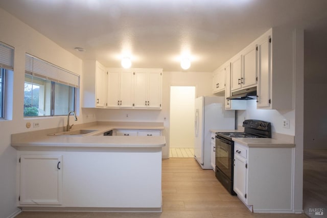 kitchen with black / electric stove, a peninsula, light countertops, under cabinet range hood, and a sink
