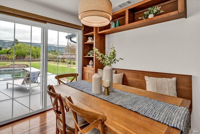 dining space featuring wood finished floors and visible vents