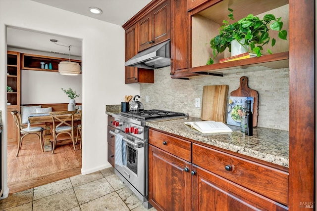 kitchen with backsplash, luxury range, light stone counters, open shelves, and under cabinet range hood