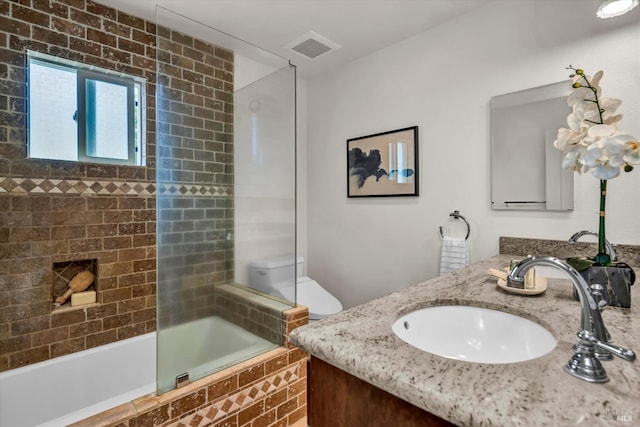 bathroom featuring tiled shower / bath combo, double vanity, visible vents, and a sink
