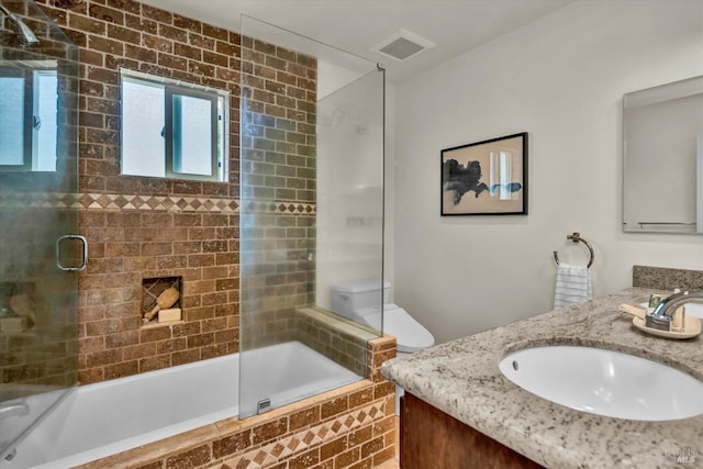 bathroom featuring vanity, tiled shower / bath combo, and visible vents
