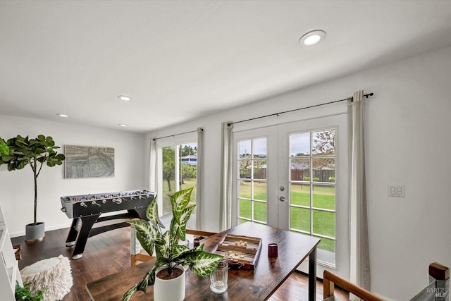 dining area featuring baseboards, french doors, wood finished floors, and recessed lighting