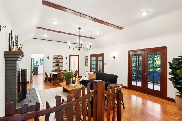 12 Jones Way, Larkspur, CA 94939 - dining room with light wood-style flooring, a healthy amount of sunlight, a brick fireplace, lofted ceiling, and french doors