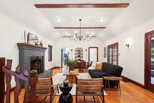 12 Jones Way, Larkspur, CA 94939 - living room featuring light wood-style floors, a fireplace, vaulted ceiling, a chandelier, and baseboards