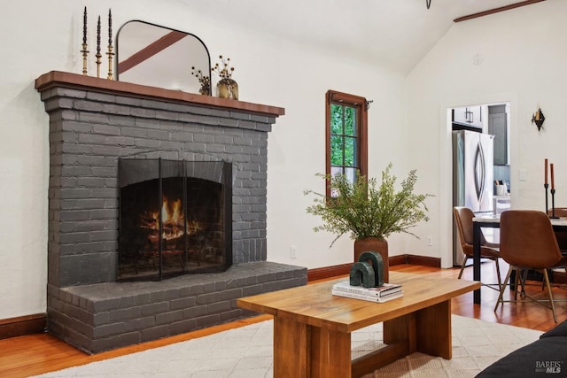 12 Jones Way, Larkspur, CA 94939 - living room with a brick fireplace, baseboards, wood finished floors, and lofted ceiling
