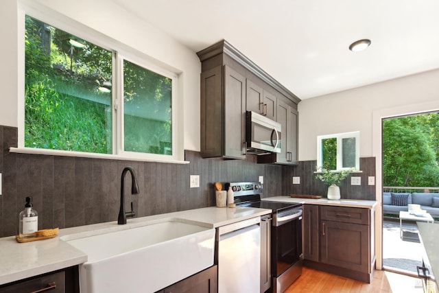 12 Jones Way, Larkspur, CA 94939 - kitchen featuring a sink, light countertops, appliances with stainless steel finishes, and decorative backsplash