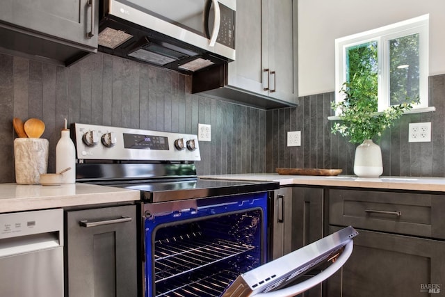 12 Jones Way, Larkspur, CA 94939 - kitchen featuring backsplash, light countertops, and stainless steel appliances