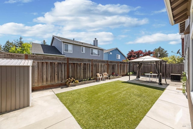 view of yard featuring central AC unit, a fenced backyard, a gazebo, and a patio