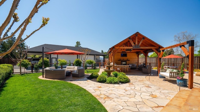 view of patio / terrace with an outdoor living space, a gazebo, and a fenced backyard