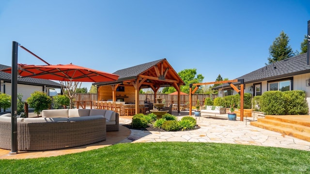 exterior space featuring outdoor lounge area, a gazebo, a fenced backyard, and a patio area