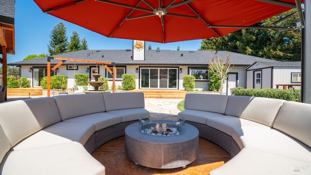 view of patio / terrace featuring an outdoor living space with a fire pit