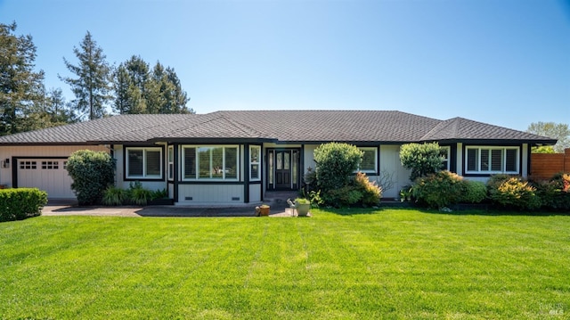 ranch-style home featuring a front lawn and an attached garage