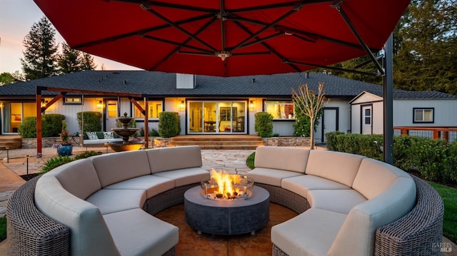 view of patio featuring an outdoor living space with a fire pit