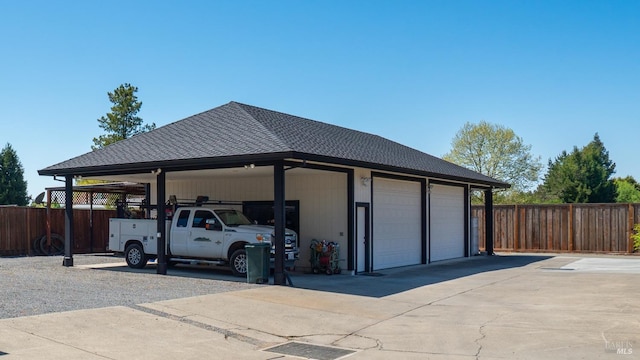 garage with a garage and fence