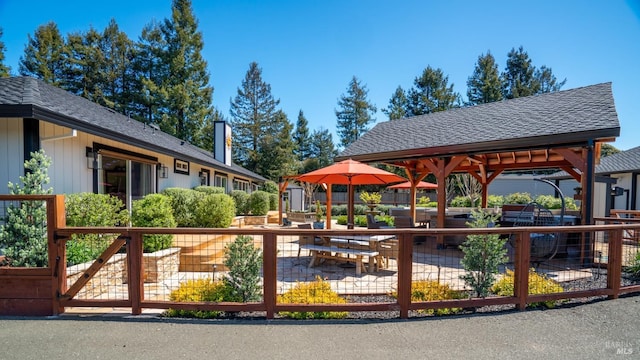 view of property's community featuring a gazebo, a patio, and fence private yard