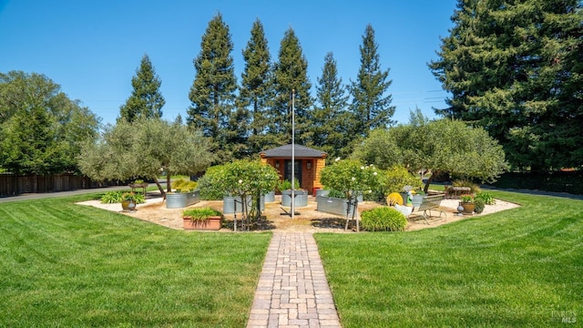 view of property's community featuring fence and a yard