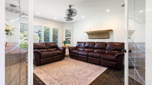 living room with recessed lighting, stone tile floors, and a wealth of natural light