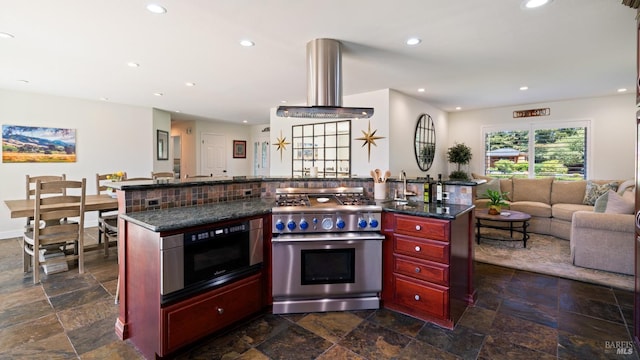 kitchen featuring built in microwave, stainless steel range, ventilation hood, reddish brown cabinets, and open floor plan