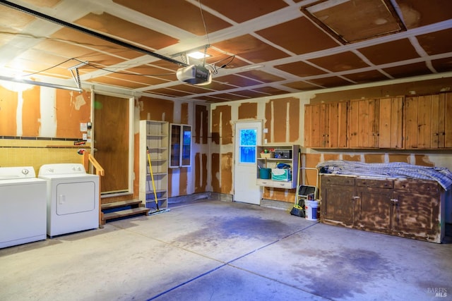 garage with washing machine and dryer and a garage door opener