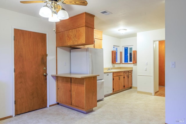 kitchen with ceiling fan, white appliances, visible vents, light countertops, and baseboards