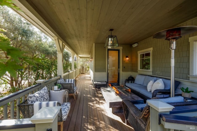 wooden deck with an outdoor living space