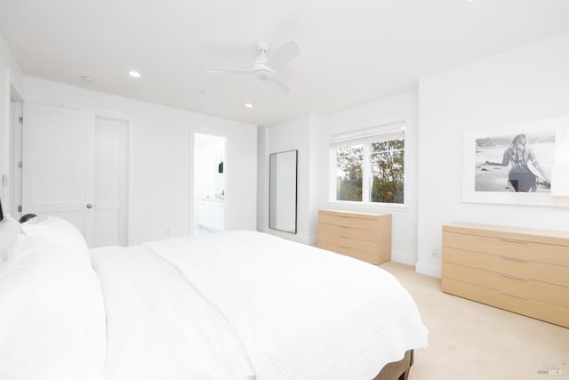 bedroom featuring light carpet, recessed lighting, ensuite bath, and ceiling fan