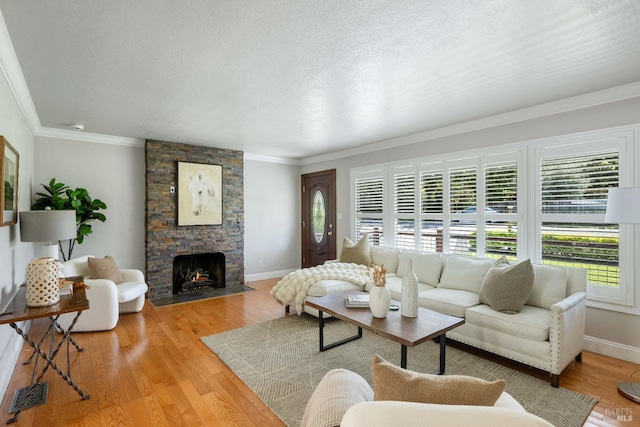 1036 Summit Ave, Napa, CA 94559 - living area with crown molding, baseboards, wood finished floors, a stone fireplace, and a textured ceiling