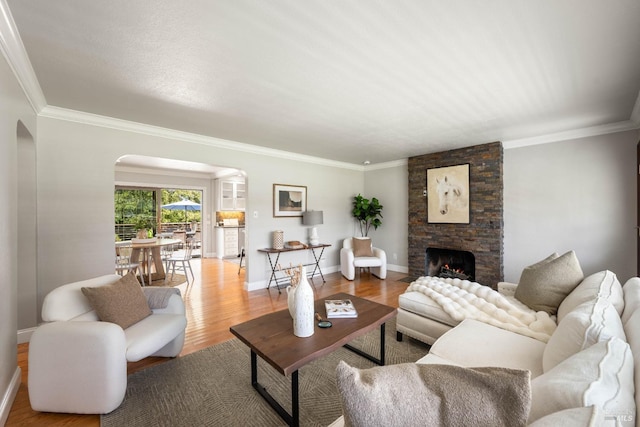 1036 Summit Ave, Napa, CA 94559 - living area with arched walkways, ornamental molding, baseboards, wood finished floors, and a stone fireplace