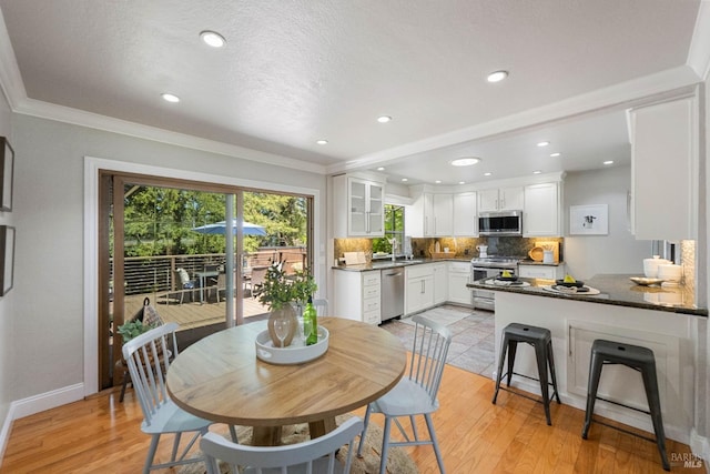 1036 Summit Ave, Napa, CA 94559 - dining area with light wood finished floors, baseboards, recessed lighting, and crown molding