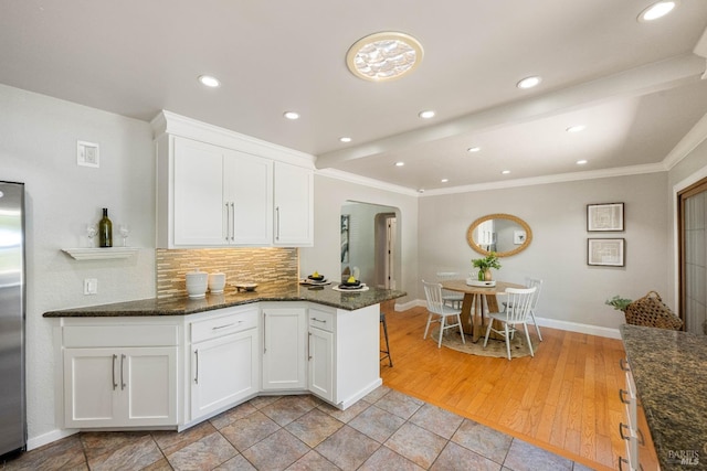 1036 Summit Ave, Napa, CA 94559 - kitchen with arched walkways, ornamental molding, decorative backsplash, white cabinets, and dark stone counters
