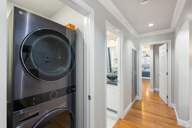 1036 Summit Ave, Napa, CA 94559 - washroom with stacked washer / drying machine, light wood-style flooring, crown molding, baseboards, and recessed lighting