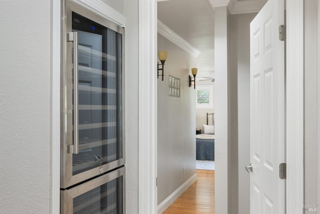 1036 Summit Ave, Napa, CA 94559 - hallway with beverage cooler, ornamental molding, light wood-style flooring, and baseboards