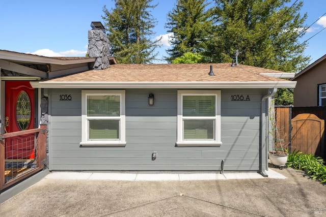 1036 Summit Ave, Napa, CA 94559 - back of house with a chimney, a shingled roof, fence, and a patio