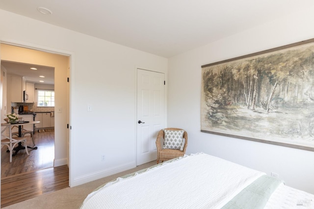 bedroom featuring wood finished floors, baseboards, and recessed lighting