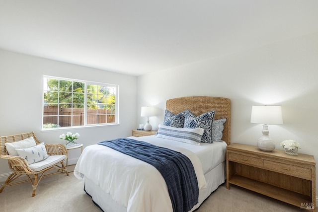 bedroom featuring baseboards and light carpet